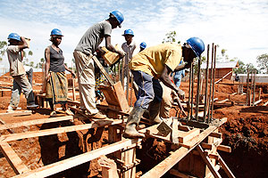 Builders at a construction site in Kigali. The pension reforms seek to enable saving even for such workers. The New Times/ File.