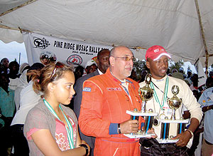 Fitidis and his co-driver Eric Maxime Nzamwite pose with their trophies after finishing third in Masaka rally. The New Times/Courtesy.