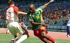 Former Cameroon international Patrick Mboma (R) in action. Net photo.