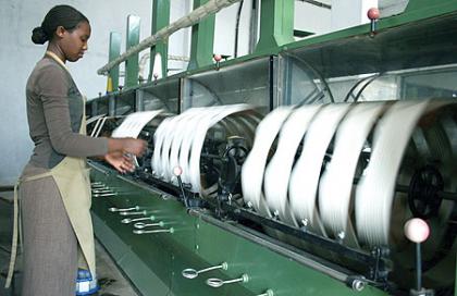 A woman spins raw silk yarn in a factory owned by local textile firm Utexwra based in  Kigali. The firm is said to be under performing. Net photo.