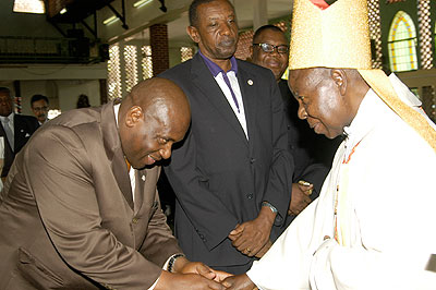 Cardinal Emannuel Wamala greets State Minister for Regional Coperation Asuman Kiyingi as Rwanda's High Commisioner to Uganda, Frank Mugambage looks on. The New Times / G.Muramira.