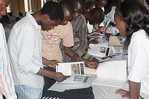 Some of the students who attended the exhibition taking a look at some of the displayed books. The New Times / Grace Mugoya.