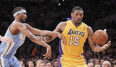 Los Angeles Lakers forward Metta World Peace, right, pulls in a loose ball away from Denver Nuggets forward Corey Brewer during the first half.