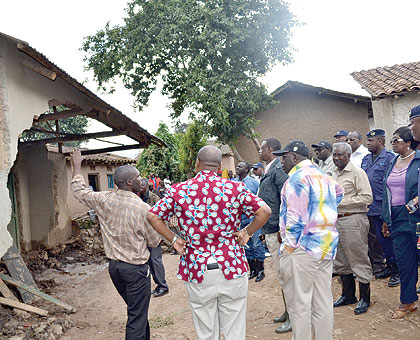 Government officials led by the Prime Minister, Dr Pierre Damien Habumuremyi (right, in cap), inspect  property destroyed by floods in  Kanama,  Rubavu District on Saturday. The New Times / Courtesy.