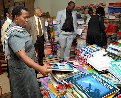 Kigali City Vice Mayor Hope Tumukunde looks at some books in the newly opened Libary on Monday. The New Times / John Mbanda.