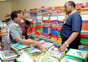 Officials looking at some books at Kigali public library. The New Times / File.