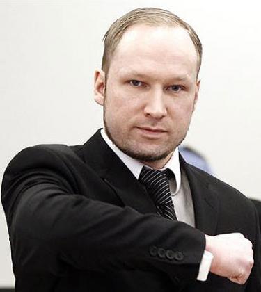 Defendant Anders Behring Breivik gestures at the start of the third day of proceedings in the courthouse in Oslo April 18, 2012. Net photo. 