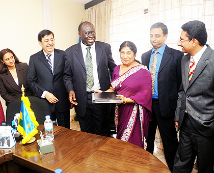 Justice Minister Tharcise Karugarama (C) and BCR Chief Executive Sajeev Anand (3rd left) with the Jobanputra family after signing the agreement. The New Times / John Mbanda.