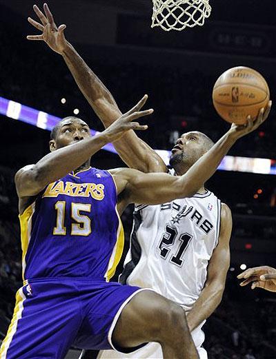 Los Angeles Lakers forward Metta World Peace attempts a shot against San Antonio Spurs forward Tim Duncan during the first half. Net photo.