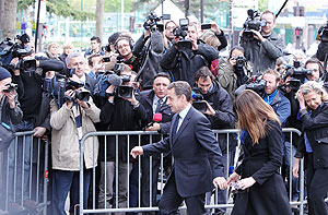 Franceu2019s President and Union for a Popular Movement (UMP) partyu2019s candidate Nicolas Sarkozy and his wife Carla Bruni leave the Lycee Jean de la Fontaine polling station after casting their votes. Net photo.