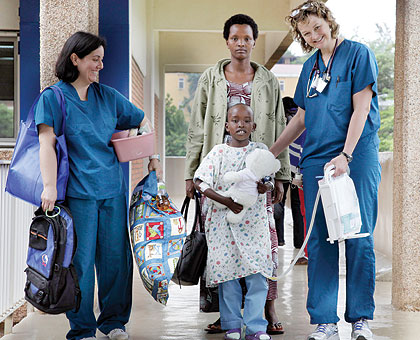 RELIEF: Seven-year-old Fidel Mihoza is one of the patients who underwent free open heart surgery at Kigali King Faisal Hospital. In this photo taken yesterday, he was in the company of his mother, Immaculu00e9e Mahombi (behind), and medics who were part of th