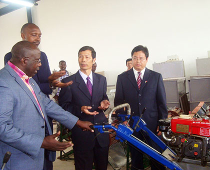 Dr Habumuremyi inspects various machines used in farming at the centre.  The New Times / JP Bucyensenge.