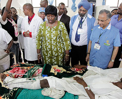 Health Minister Dr Agnes Binagwaho (L), together with the Indian Surgeons looking at a patient who underwent an operation at CHK Hospital. The New Times / Timothy Kisambira.