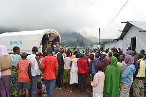 Refugees disambark from UNHCR vehicle on Tuesday. The New Times / B. Mukombozi.