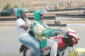 A Motorcycle transporting a passenger. The New Times / file