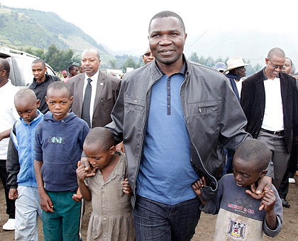 The Governor of DRCu2019s North Kivu Province, Julien Kahongya Paluku, with children during his yesterdayu2019s visit to Nkamira Transit Camp in Rubavu where nearly 6,000 congolese refugees are sheltered. The New Times / Timothy Kisambira.