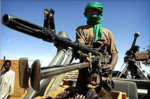 A militia man said to be working with the Sudanese Army stands on guard. Net photo.