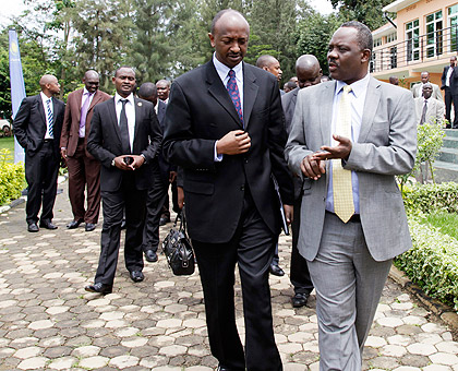 Eng. Ladcas Matindi, Principle Officer in charge of Aviation Sector at the EAC Secretariat (R), chatting with Richard Masozera, Director General of RCAA. The New Times / Timothy Kisambira.