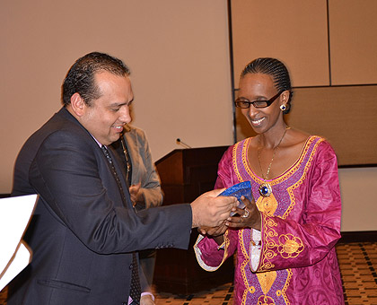 TIGO Rwanda CEO, Tom Gutjahr, presenting an award to Immaculate Bugingo, the CEO of Rwanda Gateway Ltd. The New Times / Courtesy.