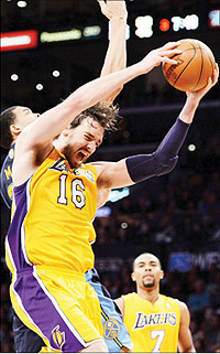 Pau Gasol of the Los Angeles Lakers grabs a rebound in front of JaVale McGee (left) of the Denver Nuggets. Net photo.