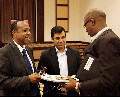 Dr George Njenga (left) of SBS interacts with Sandeep Sharma of Fina Bank and Eric Rugwizangoga of WELL International, at the launch of TED. The New Times / T. Kisambira.