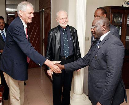 Grant Foote (L), the Associate Director of NCAR shakes hands with Premier Habumuremyi while Joan Clos (middle) the Executive Director of United Nations Human Settlement Programme looks on. The Sunday Times/ Timothy Kisambira.