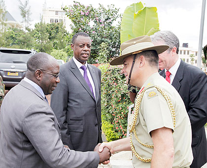 PM Dr Pierre Damien Habumuremyi shakes hands with the Australian Defence Attache, African Union, Col. James Davey, as Defence Minister Gen. James Kabarebe (C) and the Australian High Commissioner to Rwanda, Gaeoff Tooth, look on. The New Times / T Kisambi