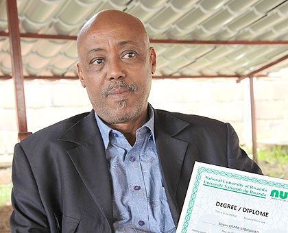 Soyan Omar, Managing Director of Fodey Security holding his Academic certificate yesterday. The New Times / Timothy Kisambira.