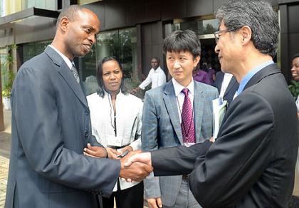 The PS, Ministry of Infrastructure, James Kamanzi, shakes hands with South Korean Ambassador to Rwanda, Heon Lee, as the Director General, Rwanda Housing Authority, Ester Mutamba, and Country Programme Director, Global Green Growth Institute (GGGI), Myung