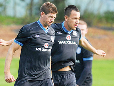 Former captain John Terry (R) linked up with newly-appointed skipper Steven Gerrard (L) and the squad wonu2019t be able to take their WAGS at the Euros. Net photo.