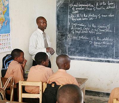 a Teacher conducts a lesson in class. Students are now instructed in English in school after a change from French. The Sunday Times / File.