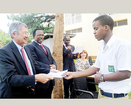 US Ambassador, Donald Koran, awards a certificate to one of the Students. The Sunday Times/John Mbanda.