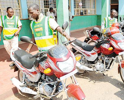 Youth admire new motocycles acquired through COOJAD loans. The Sunday Times/File.