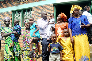 Families walk home with children  from Mpore Peffa orphanage in Gikondo which was closed last week. The New Times / John Mbanda.