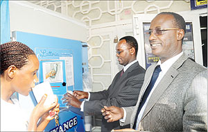 Inyange Industries Chairman prof. Mannaseh Nshuti (R) and the Permanent Secretary in the Ministry of Trade and Industry Emmanuel Hategeka serve milk from a public dispenser after its launch in Remera on Thursday. The New Times Times / File.