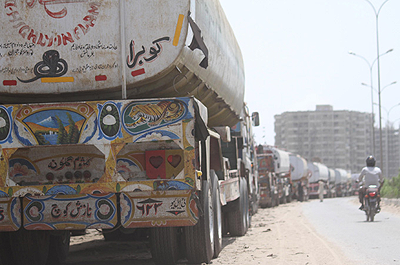 Trucks carrying logistical supplies for NATO forces in Afghanistan, parked at a compound in Karachi, Pakistan. Net photo.