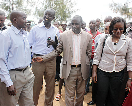 Minister Mukaruliza (R), Bugesera Mayor, Louis Rwagaju (2nd R) and district officials talk to residents yesterday. The New Times / E. Munyaneza)