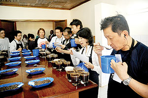 Japanese coffee cuppers taste the aroma of Rwanda coffee on Tuesday. The New Times /J. Mbanda.