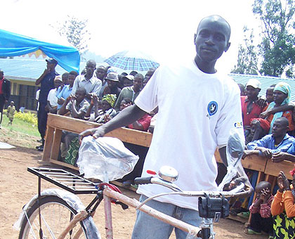 A member of Turwanye Ibiyobyabwenge coop walks away with a bicycle, courtesy of Rwanda National Police. The New Times / JP. Bucyensenge.