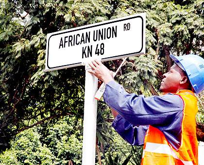 A technician puts up a street sign in Kigali. The New Times / Timothy Kisambira.