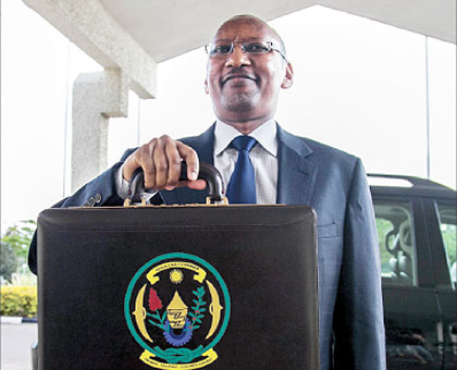 The Minister of Finance and Economic Planning, John Rwangombwa, arrives at the Parliamentary Buildings, Kimihurura, yesterday to present the 2012/13 National Budget. The New Times / Robyn Spector.