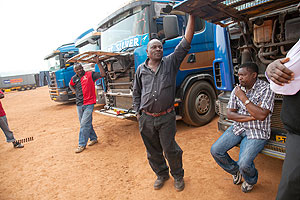 A truck driver speaks with a journalist at MAGERWA . The New Times / Robyn Spector.