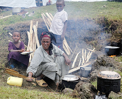 A Congolese woman prepares a family meal in refugee camp in Rwanda. The New Times / Timothy Kisambira.