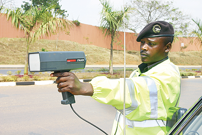 A traffic officer using a speed gun. The New Times / File.