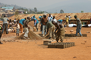 Residents make bricks for 9YBE programme. The New Times / File.