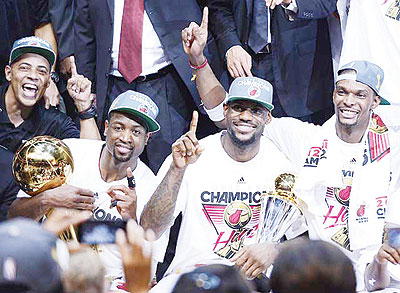 Dwyane Wade, LeBron James and Chris Bosh made amends for losing in last year's finals by getting the job done this season. Net photo.