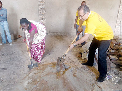 MTN Rwanda's Mikkawi (R) and Ruhango vice mayor in charge of social affairs, Jolie Germaine Mugeni, take part in the renovations. The New Times / JP Bucyensenge.