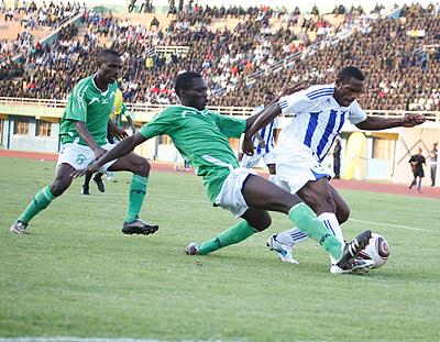 Rayon Sports striker Bokota Labama being pursued by Kiyovu defender Godffrey Katerega during the first leg match played on Thursday. Sunday Sport / T. Kisambira