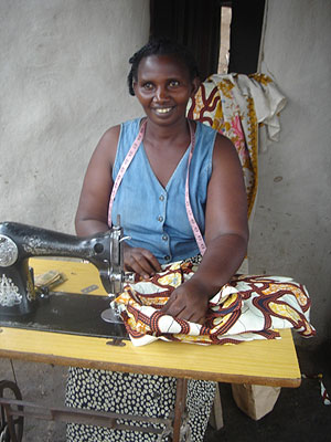 A woman busy at work with her sewing machine. The New Times / File.