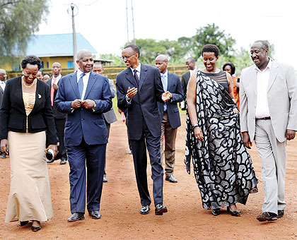 President Paul Kagame and his wife, Jeannette, chat with Ugandau2019s Sam Kutesa (2nd L) and his wife Edith Gasana (L), and Gen. Salim Saleh (R) after the President had unveiled a tombstone in honour of the late Kosiya Kyamuhangire at Gahini, Kayonza District